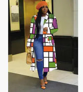 A stylish woman wearing a colorful Lapel Windbreaker Jacket for Stylish Outerwear with orange beanie and ripped jeans.